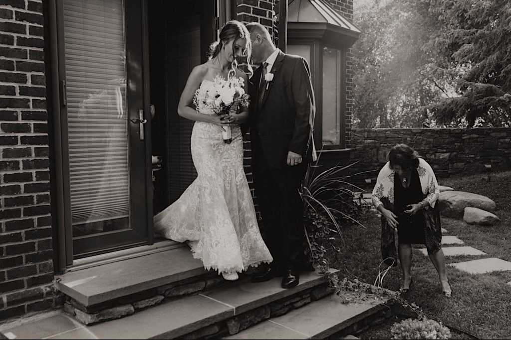 bride walking out to backyard wedding in ann arbor michigan 