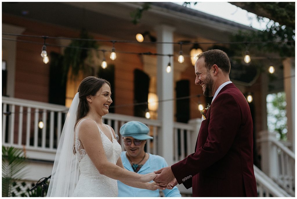 The couple holds hands and smiles at each other during the compass point events wedding ceremony