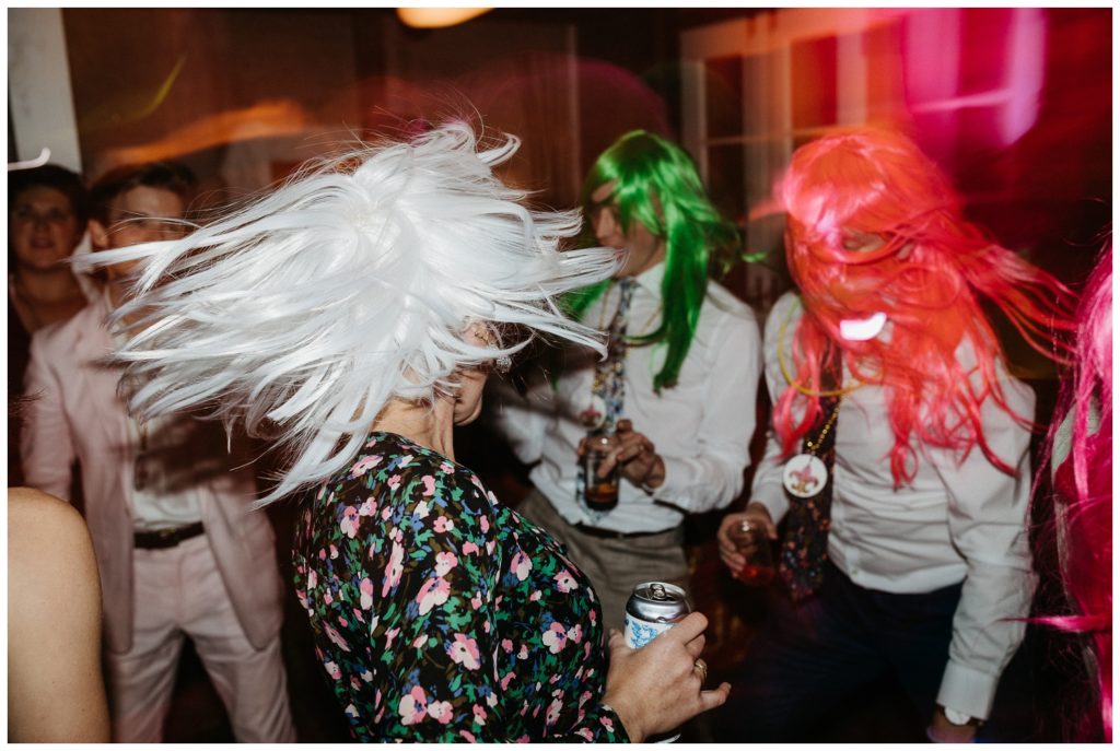 Guests dance in wigs at the Tigermen Den wedding