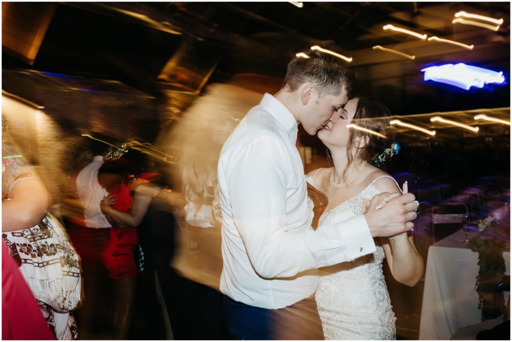 The bride and groom kiss on the dance floor at Capulet New Orleans