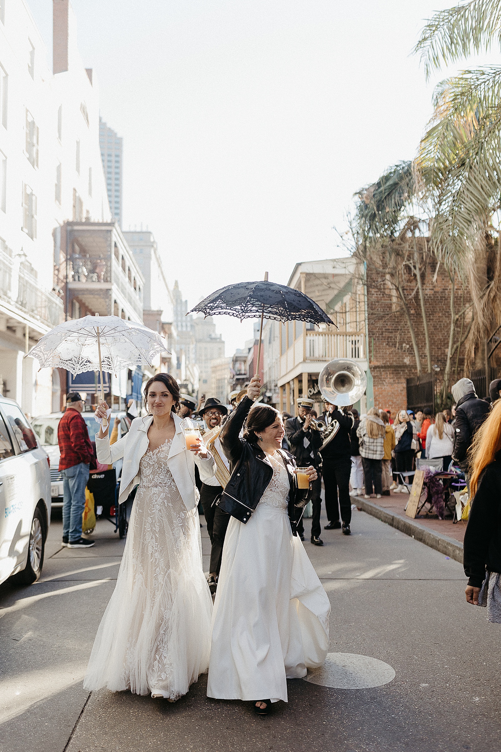 Two brides dance in the street at a French Quarter wedding