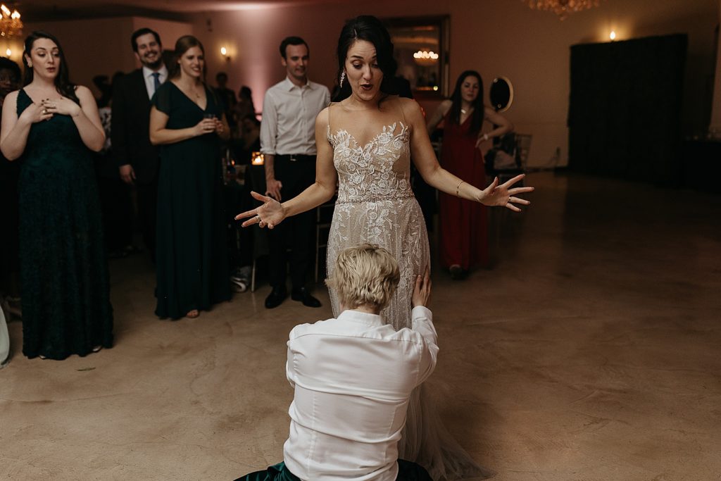A guest dances with a bride.