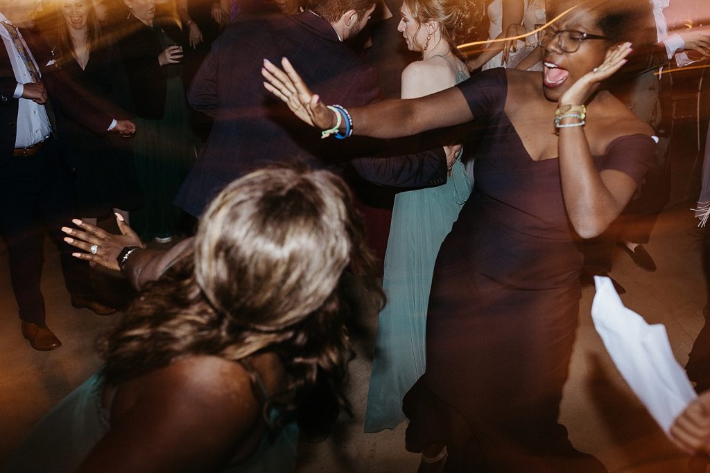 Guests dance together.