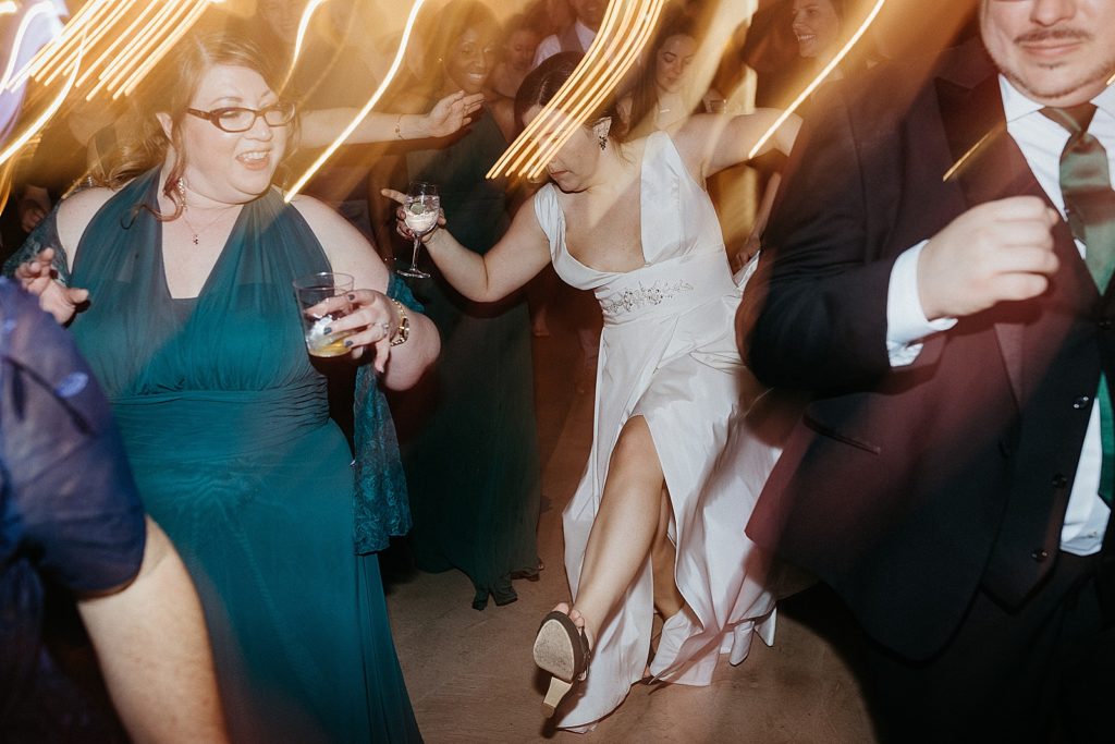 Guests do a line dance with a bride.