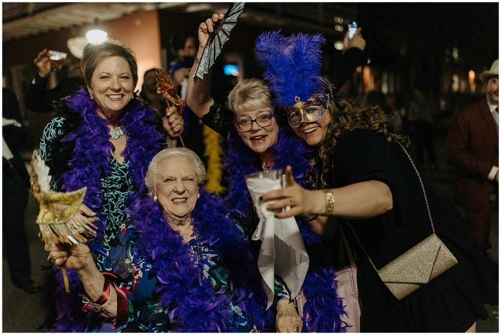 Guests wear blue feather boas.