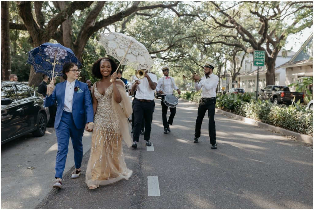 Alex and Isatu lead their guests in a second line after their Degas House wedding ceremony.