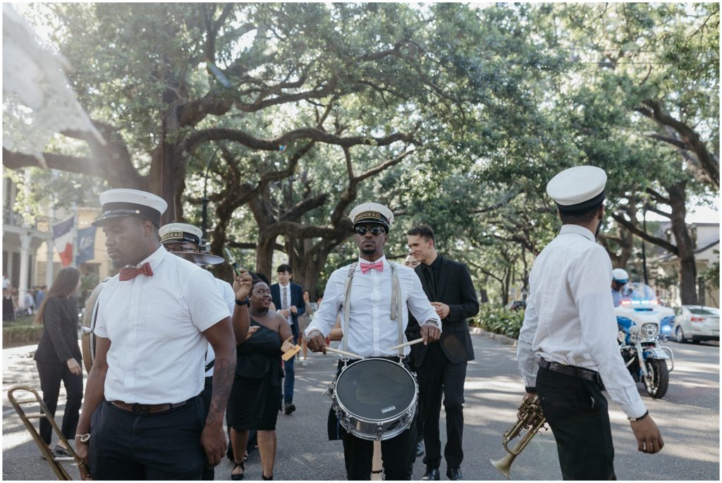 Brass band members walk in Esplanade Avenue.