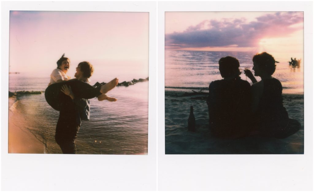 Polaroid engagement photos show Britt and Em on the lake shore.
