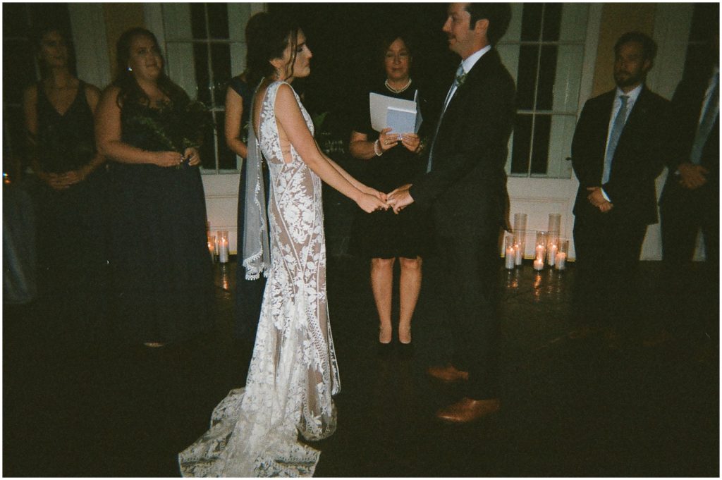 Michael and Marissa hold hands during their wedding ceremony in New Orleans.