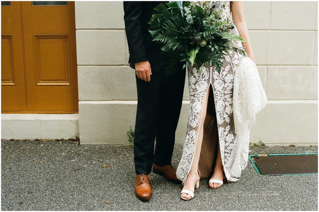 The couple shows their white and brown wedding shoes.