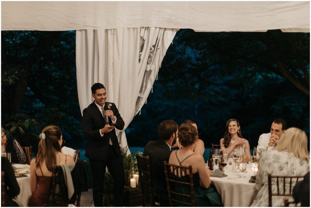 A groomsman gives a toast at the reception.