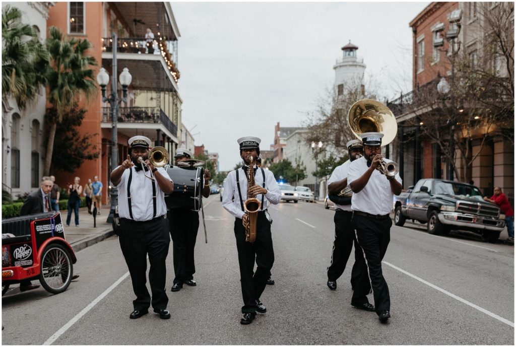 A brass band plays in a French Quarter street.