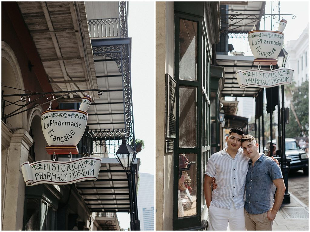 Enrique and Caleb lean against each other under the Pharmacy Museum sign.
