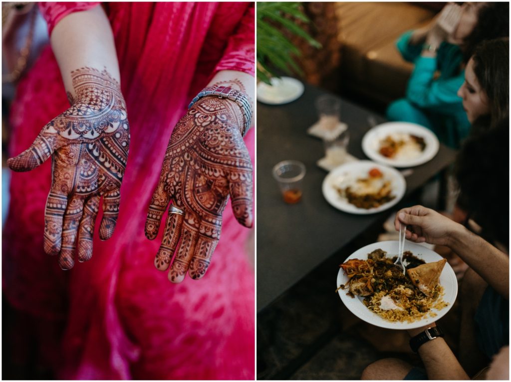 A woman in a pink sari holds out her hands to show traditional henna designs.