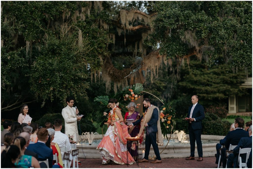The couple walks in a circle at the wedding altar in City Park.