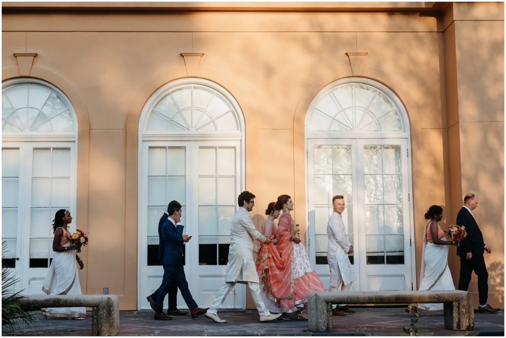 Tiffany walks with friends towards a wedding reception at the Pavilion of Two Sisters.