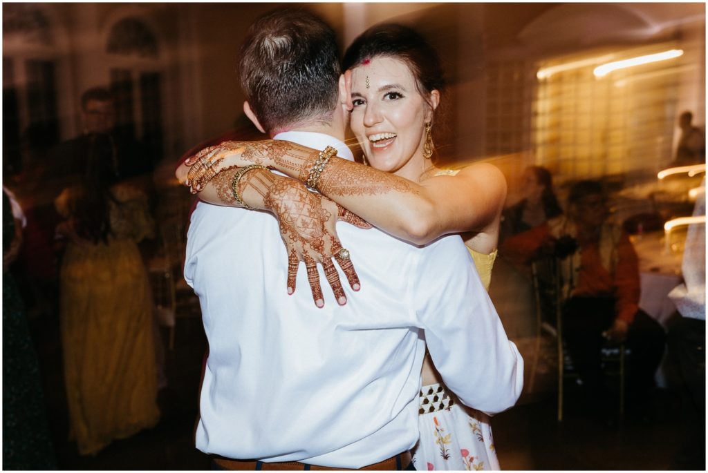 A couple laughs while they dance at their New Orleans wedding reception.