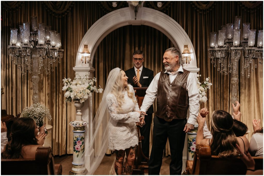 Jake and Nicole laugh and turn to face their guests at the New Orleans wedding chapel.