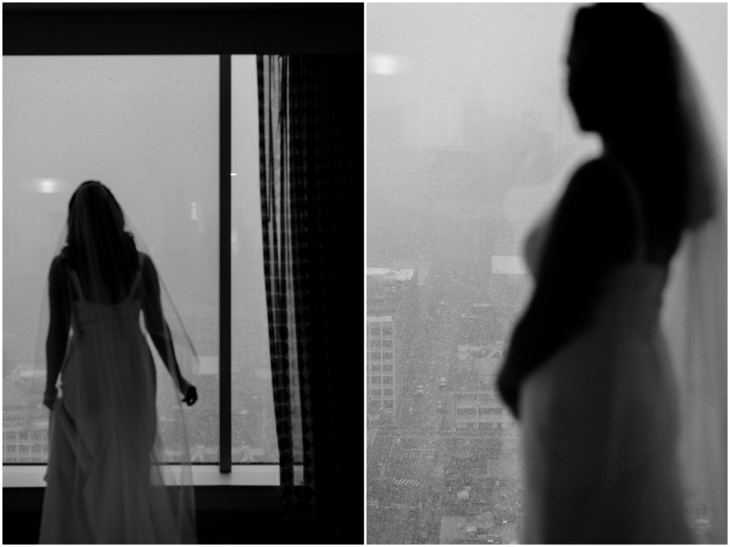A bride looks out the Greektown Hotel window at falling snow.