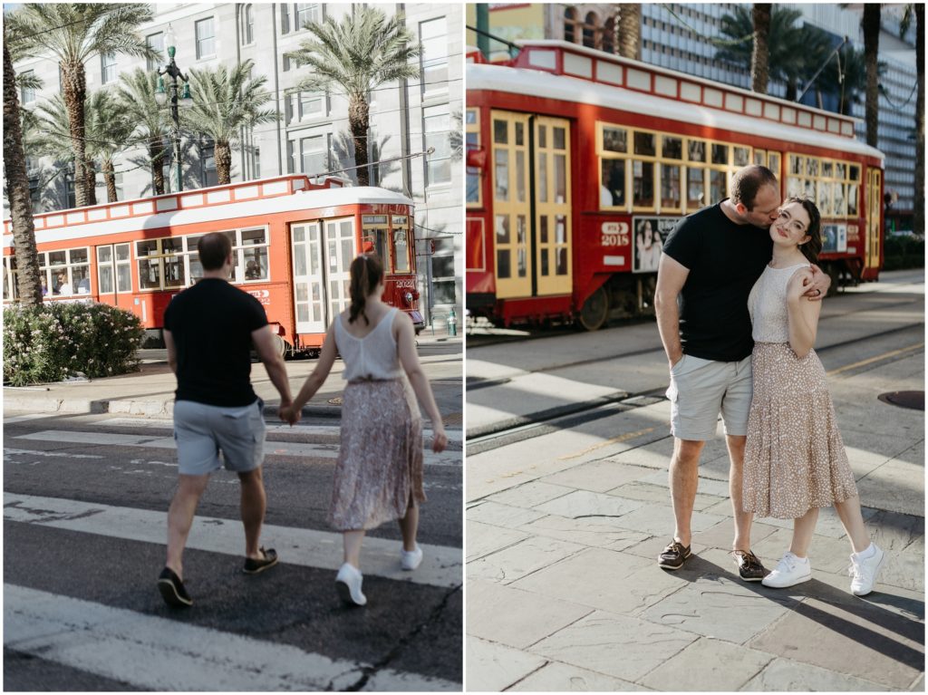 A newly wed couple crosses Canal Street in front of the red street car.