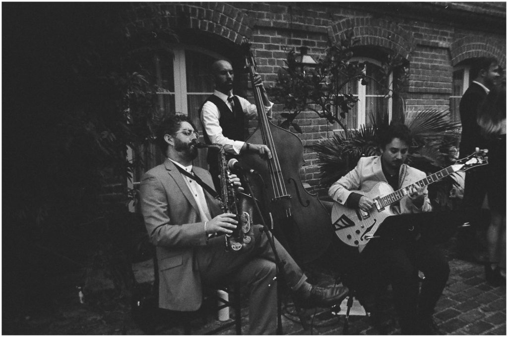 A jazz band plays at a wedding cocktail hour in a New Orleans courtyard.