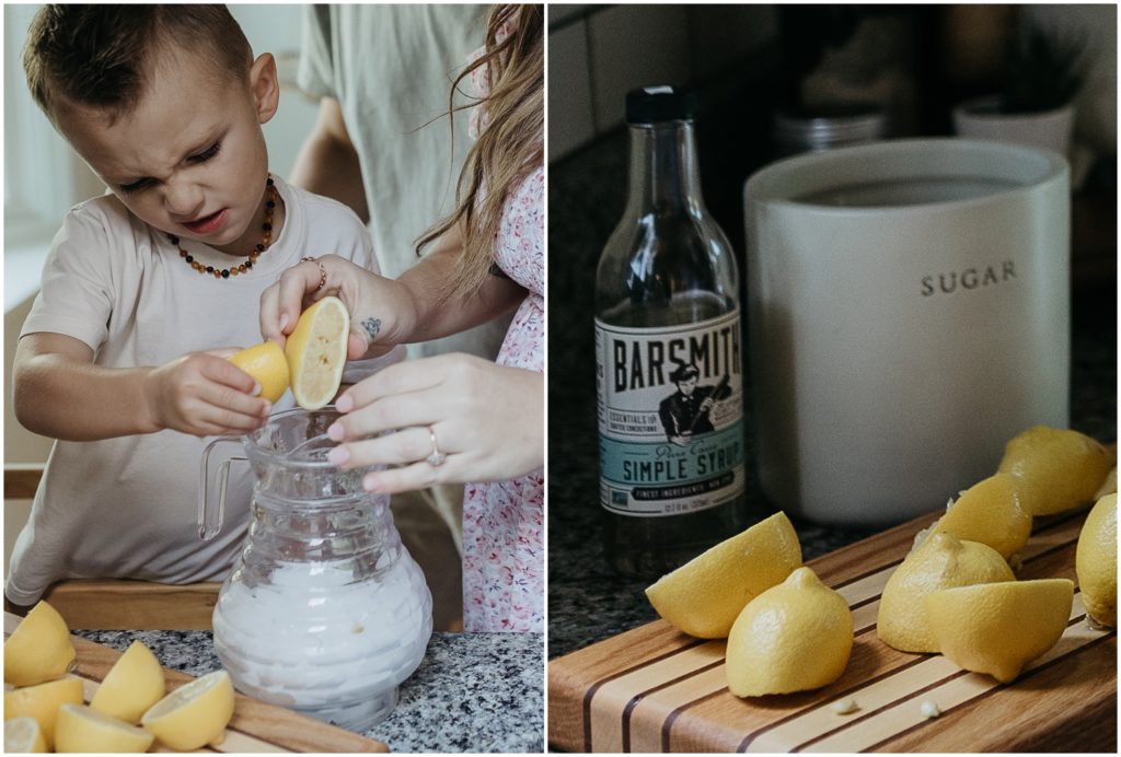 Lemons sit beside a bottle of simple syrup and a glass pitcher.
